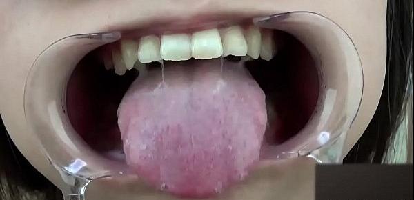  A woman shows her gums and sputs saliva